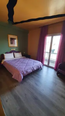 a bedroom with a bed and a large window at Athens Lydia Hotel in Athens