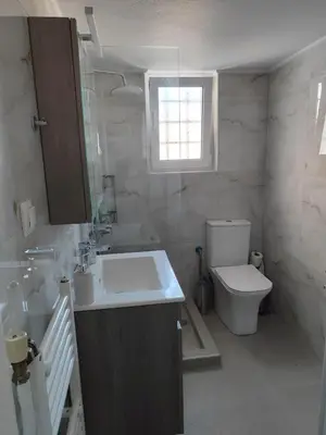 a bathroom with a sink and a toilet at Comfortable penthouse in Kallithea in Athens