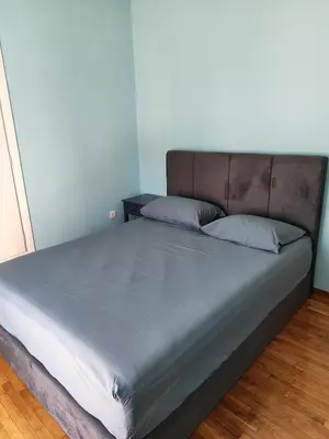 a bed in a room with a blue wall at Comfortable penthouse in Kallithea in Athens
