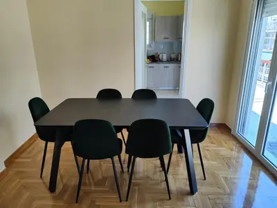 a black dining room table with four black chairs at Comfortable penthouse in Kallithea in Athens