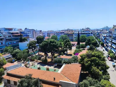 an aerial view of a city with trees and buildings at Comfortable penthouse in Kallithea in Athens