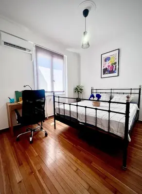 a bedroom with a bed and a desk and a chair at Apartment in the center of Athens! in Athens
