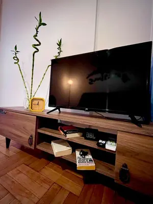 a large flat screen tv on a wooden entertainment center at Apartment in the center of Athens! in Athens