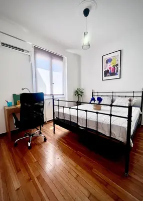 a bedroom with a bed and a desk and a chair at Apartment in the center of Athens! in Athens