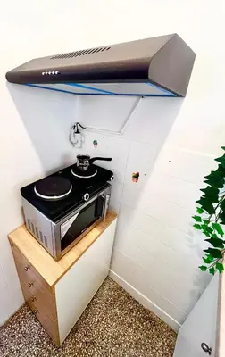 a kitchen with a stove in a room at Apartment in the center of Athens! in Athens