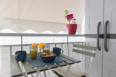 a table with a bowl of food on a balcony at Urban Ceramic Apartment by GHH in Athens