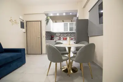 a kitchen and dining room with a table and chairs at Urban Ceramic Apartment by GHH in Athens