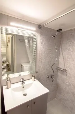 a bathroom with a sink and a mirror at Urban Ceramic Apartment by GHH in Athens