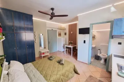 a bedroom with a bed and a ceiling fan at Pavlina Artistic Βeauty 33sqm metro 7' in Athens