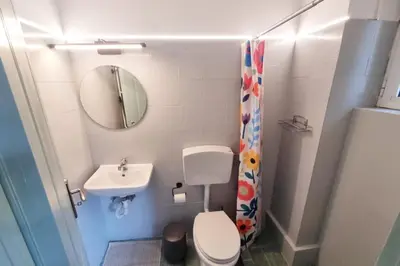 a small bathroom with a toilet and a sink at Pavlina Artistic Βeauty 33sqm metro 7' in Athens