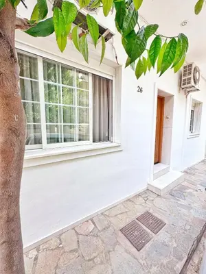 a white house with a window at 26 HoMe in Athens