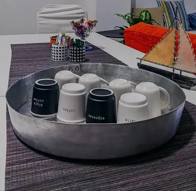 a bunch of cups in a bowl on a table at 26 HoMe in Athens