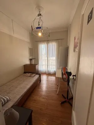 a small room with a bed and a window at Onix 2 in Athens
