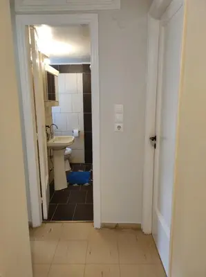 an empty bathroom with a sink and a toilet at Onix 2 in Athens