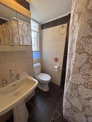 a bathroom with a white toilet and a sink at Onix 2 in Athens
