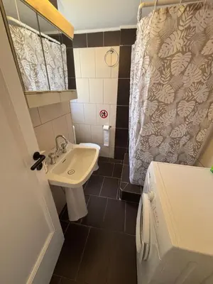 a small bathroom with a sink and a toilet at Onix 2 in Athens