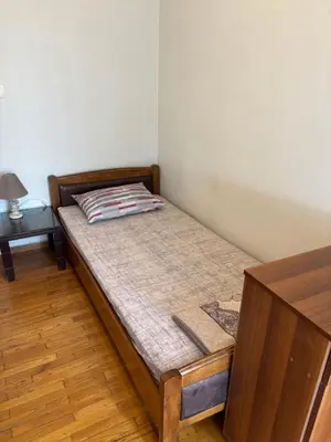 a small bed in a corner of a room at Onix 2 in Athens