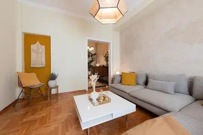 a living room with a couch and a table at Piraeus Home in Piraeus