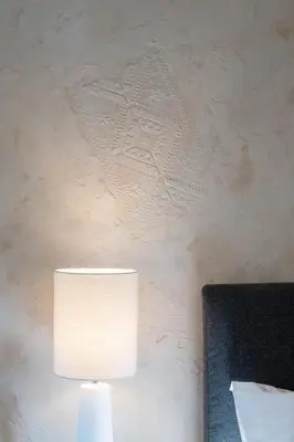a white lamp on a table next to a wall at Piraeus Home in Piraeus