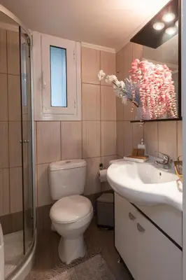 a bathroom with a toilet and a sink at Piraeus Home in Piraeus