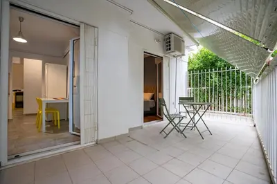 a patio with chairs and a table on a balcony at Backyard Bliss in Ano Patisia by ΜΡS in Athens