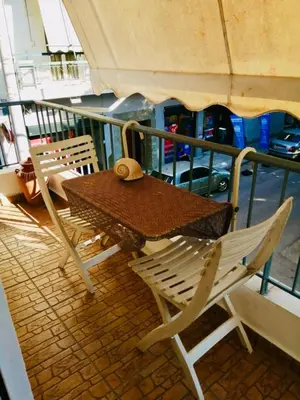 a table and chairs on the balcony of a boat at Filio House-Feels Like Home in Athens