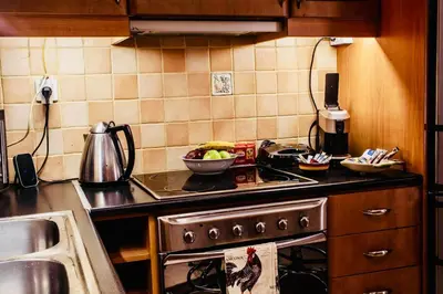 a kitchen with a stove and a bowl of fruit at Filio House-Feels Like Home in Athens