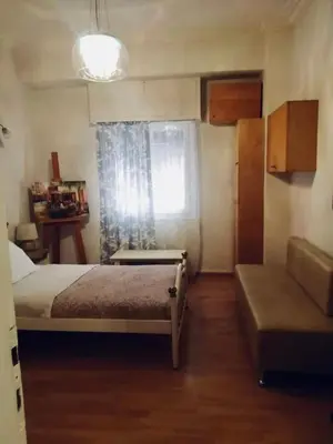 a bedroom with a bed and a window and a couch at Filio House-Feels Like Home in Athens