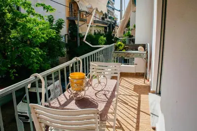 a balcony with a table and chairs on a balcony at Filio House-Feels Like Home in Athens