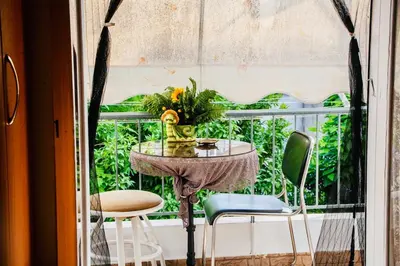 a table and two chairs on a balcony at Filio House-Feels Like Home in Athens