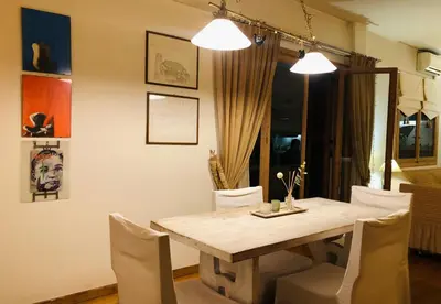a dining room with a wooden table and chairs at Zenscapes in Athens