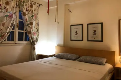 a bedroom with a bed with two pillows and a window at Zenscapes in Athens