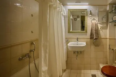 a bathroom with a shower curtain and a sink at Cool ambiance, 2Brs , Private Garden & Parking in Athens