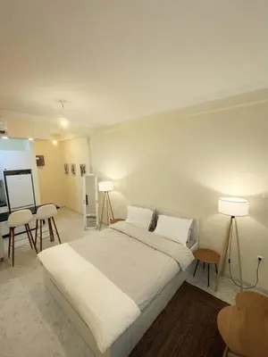 a bedroom with a large white bed and two lamps at ZEUS - Zen Exarchia Urban Studio in Athens