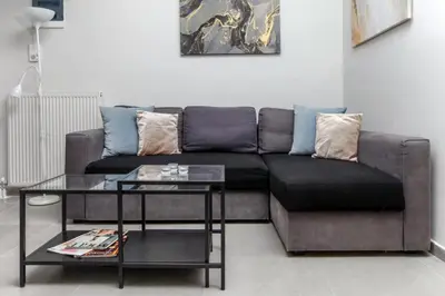 a living room with a couch and a table at Jocasta - Cocoon Apartment Near Metro Station in Athens