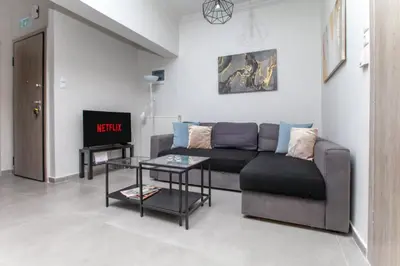 a living room with a couch and a table at Jocasta - Cocoon Apartment Near Metro Station in Athens