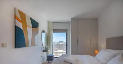 a bedroom with a bed and a painting on the wall at Sokio Attiki Hotel, BW Premier Collection in Athens