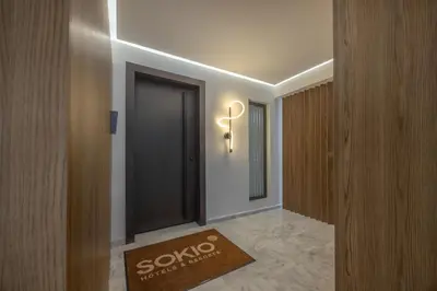 a hallway with a door with a sign on it at Sokio Attiki Hotel, BW Premier Collection in Athens