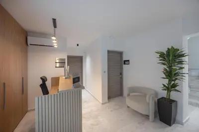 a living room with a couch and a table and a plant at Sokio Attiki Hotel, BW Premier Collection in Athens