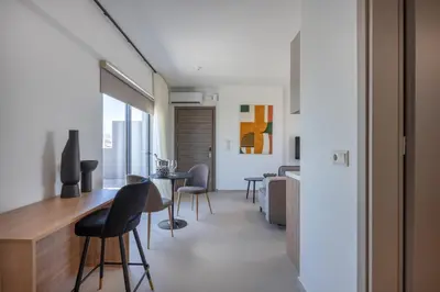 a living room with a table and chairs at Sokio Attiki Hotel, BW Premier Collection in Athens