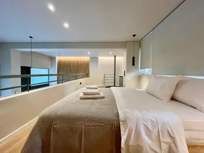 a bedroom with a large bed with towels on it at Loft in Pagkrati in Athens