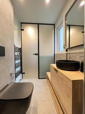 a bathroom with a toilet and a sink and a mirror at Loft in Pagkrati in Athens