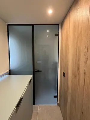 a sliding glass door in a kitchen with a counter at Loft in Pagkrati in Athens