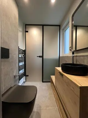 a bathroom with a toilet and a sink and a mirror at Loft in Pagkrati in Athens