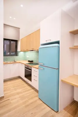 a blue refrigerator in a kitchen with white cabinets at The New Flat 183 - Ground floor, fully renovated in Athens