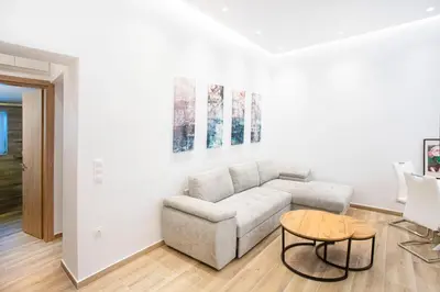 a living room with a couch and a table at The New Flat 183 - Ground floor, fully renovated in Athens