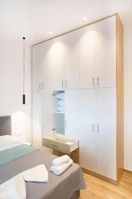 a bedroom with white cabinets and a bed at The New Flat 183 - Ground floor, fully renovated in Athens