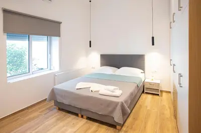 a bedroom with a bed with two towels on it at The New Flat 183 - Ground floor, fully renovated in Athens