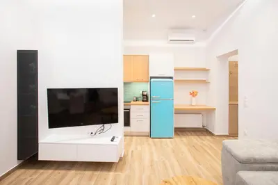 a living room with a tv and a kitchen at The New Flat 183 - Ground floor, fully renovated in Athens