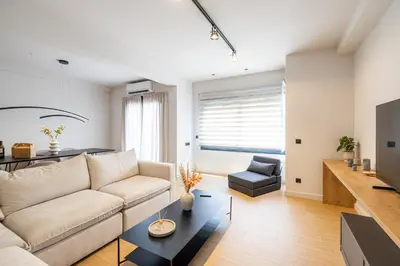 a living room with a couch and a table at Rooms151 Premium Suite in the Center of Athens 4th floor-8 in Athens
